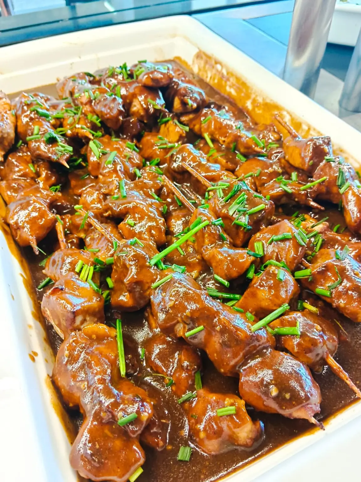 Glazed chicken bites finished with fresh herbs